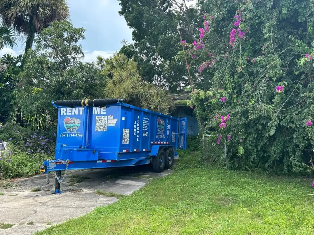 Driveway-safe 17-yard dump trailer parked in a residential driveway.